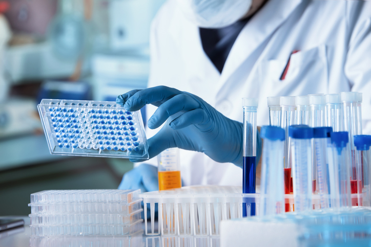 Lab technician analyzing mesothelioma diagnostic tests using biomarker samples in a clinical setting