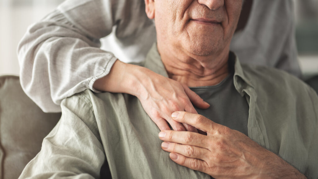 Older man comforted by caregiver, symbolizing strength, support, and hope for patients facing a mesothelioma prognosis.