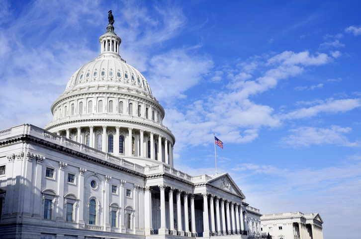 U.S. Capitol building under blue sky as Congress considers bipartisan bill to ban asbestos
