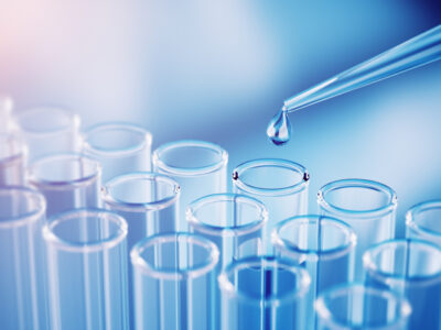 Laboratory pipette dropping liquid into test tubes representing FDA-approved VT3989 mesothelioma treatment research