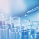 Laboratory pipette dropping liquid into test tubes representing FDA-approved VT3989 mesothelioma treatment research
