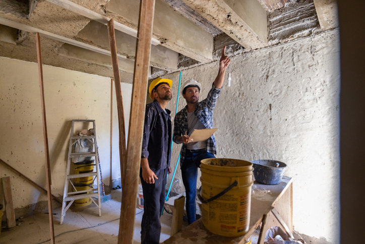 homeowner reviewing renovation plans for winter while checking for Home Renovations and Asbestos hazards