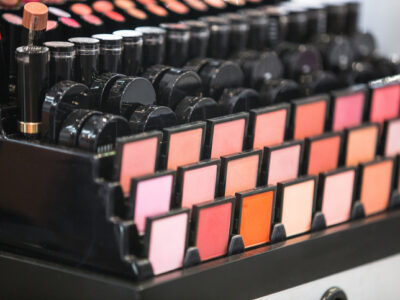 Display of women’s cosmetics and makeup powders highlighting talc safety concerns in Making America Toxic Again article