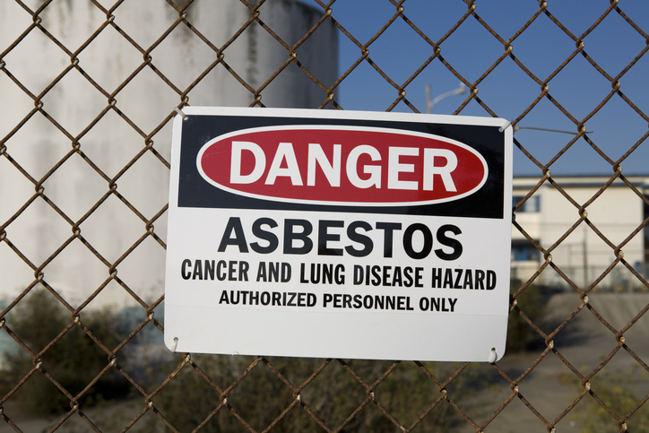 Warning sign reading “Danger Asbestos” highlighting how asbestos exposure causes cancer and lung disease risks.