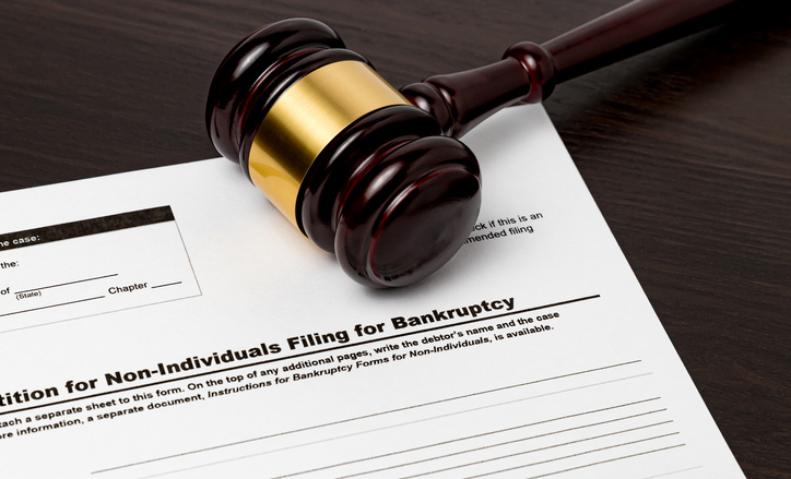 Gavel resting on Chapter 11 bankruptcy filing document related to asbestos claims