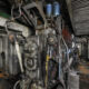 Vintage ship engine room with dense piping, valves, and machinery where asbestos insulation was widely used