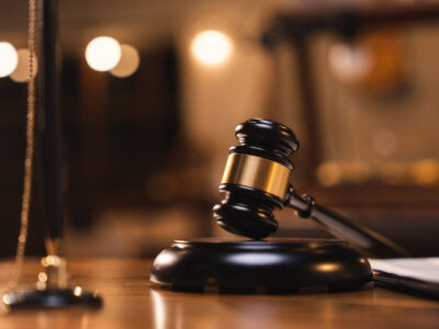 Gavel resting on a sound block in a dimly lit courtroom, representing the federal ruling in the talc research lawsuit