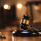 Gavel resting on a sound block in a dimly lit courtroom, representing the federal ruling in the talc research lawsuit